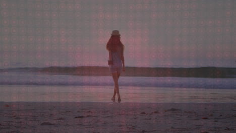 woman walking barefoot across wet beach under sunset sky, displaying animated health heart icon