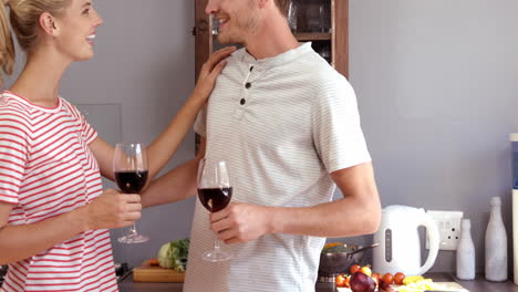 couple drinking red wine while cooking