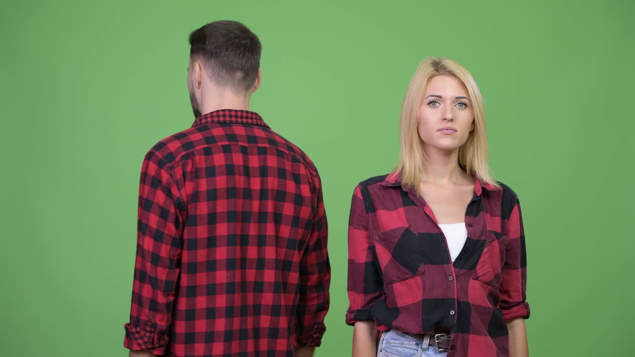 Young man turning around and smiling after together with young woman