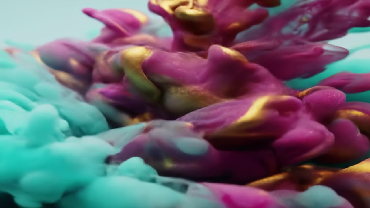 Mesmerizing patterns emerge as vibrant colors swirl and blend together, showcasing a beautiful display of fluid dynamics. The flowing motion captivates and intrigues the viewer.