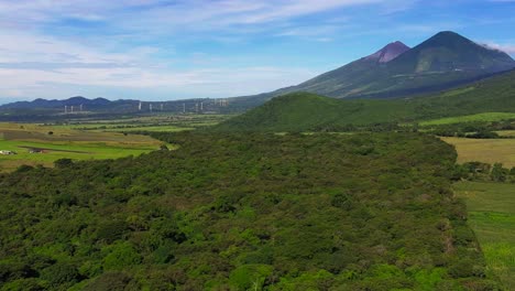 aerial view of cornfields with pacaya volcano in the distance, wind turbines and peña de oro