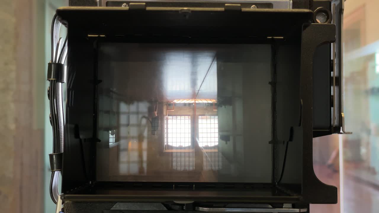 Large format camera's ground glass viewfinder displaying inverted image