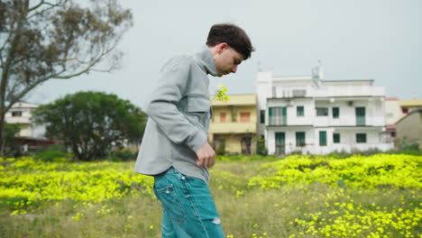 man putting yellow flowers in the shirt pocket