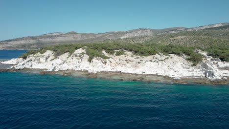 drone rotating view of aliki ancient marble quarry with turquoise water and large white pieces of marble, thassos, greece