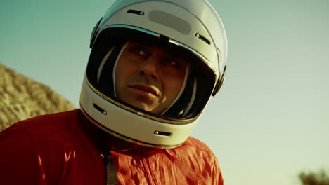 astronaut with helmet looks around at the hostile planet on which he landed