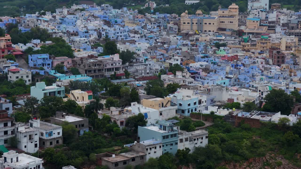 Aerial View of Crowded Blue City Houses at Mountain Base in the Evening