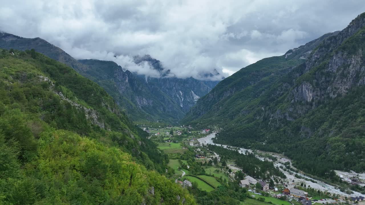 Aerial: valley during the day with cloudy sky in Theth national park, Shkoder County, Albania, establishing drone shot
