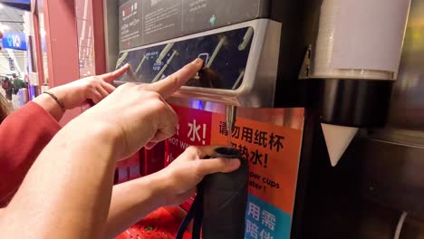 people using a water dispenser machine