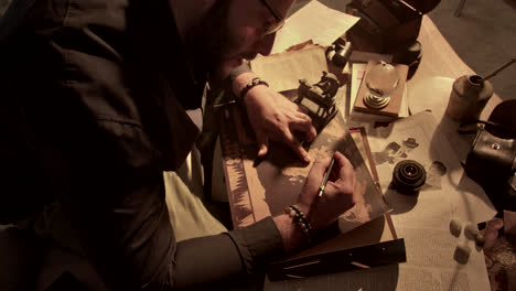man studying a vintage world map
