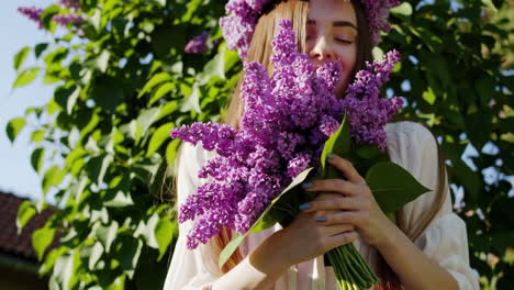 Young Woman Smelling Lilac Flowers with a Flower Crown