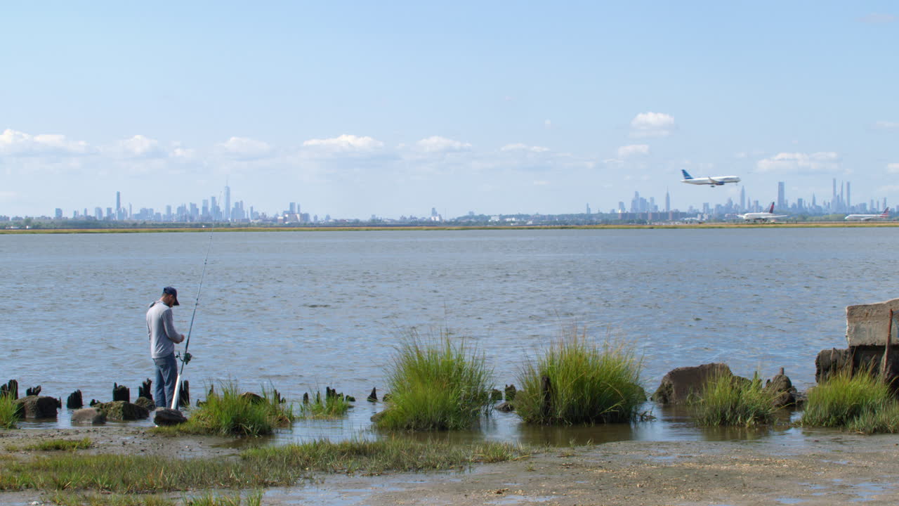 Man Prepares Fishing Rod and Walks Away in Queens New York Near JFK Airport