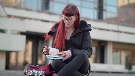 young hipster student can't find the information in a book and searches for the answer using her phone.