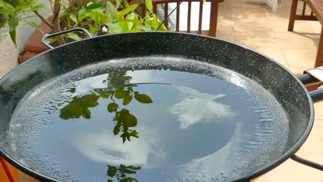 typical cooking pan with olive oil to prepare traditional valencian paella, spain