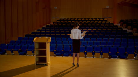 young caucasian businesswoman practicing speech in empty auditorium 4k