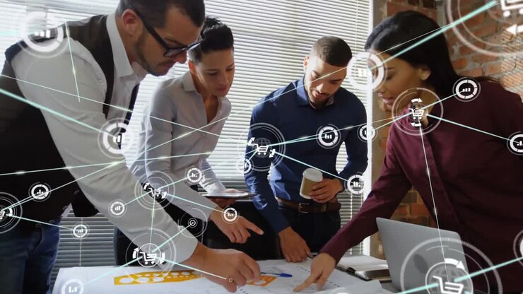 Animation of network of digital icons over diverse colleagues discussing over a plan at office