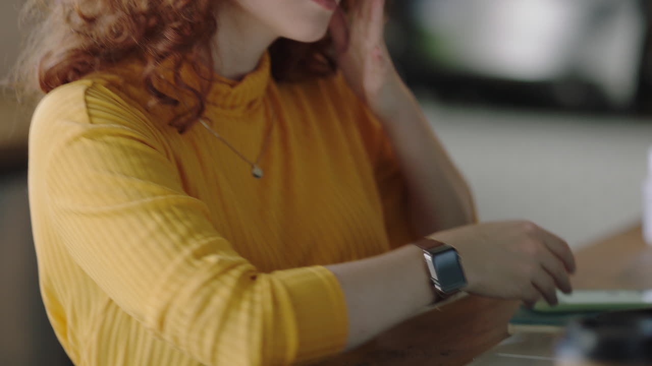 portrait beautiful young redhead woman using smartphone in cafe browsing online social media messages enjoying drinking coffee sharing lifestyle reading mobile phone communication wearing glasses