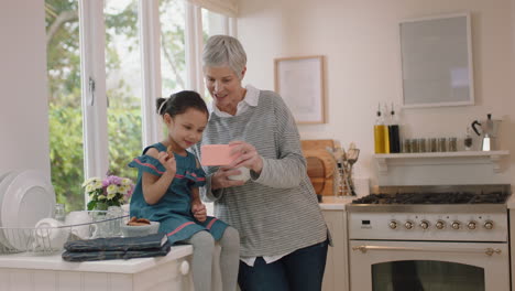 grandmother and child using smartphone having video chat little girl sharing vacation weekend showing cookie with granny enjoying chatting on mobile phone at home with granddaughter