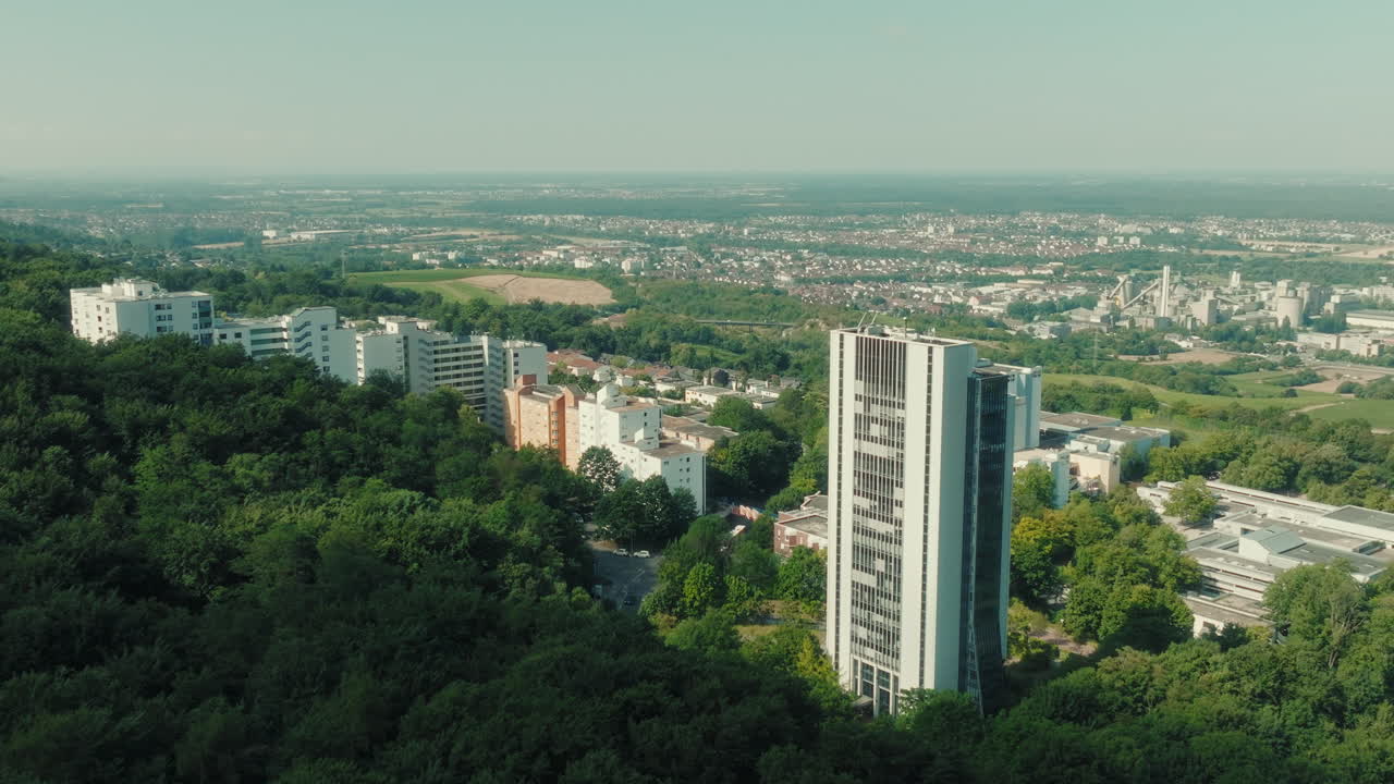 Pan drone shot of Emmertsgrund neighborhood and white buildings during the day in Heidelberg, state of Baden-Wurttemberg, Germany