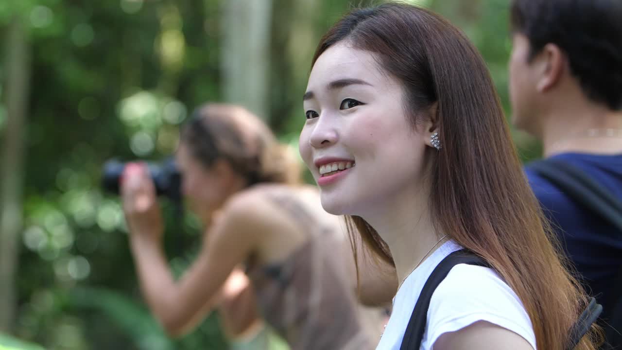 Smiling Asian Woman in a Forest