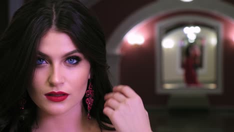 captivating portrait of a glamorous woman with striking blue eyes and elegant earrings, reflecting beauty and confidence in a stylish indoor setting