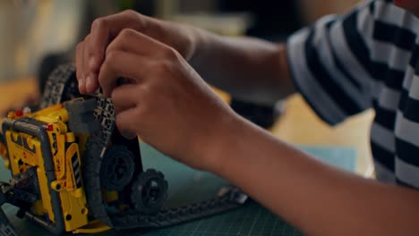 child building a lego robot toy