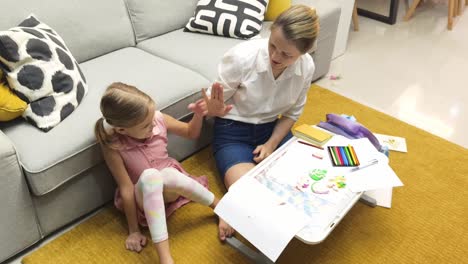 mother and daughter doing homework together at home