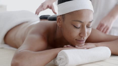 Woman-Receiving-A-Massage-With-Hot-Stone