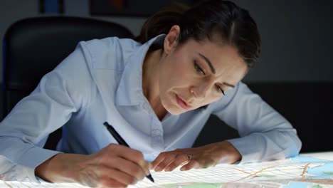 a skilled artist meticulously works on intricate designs at a well-lit desk. the atmosphere is calm, with attention to detail evident in each stroke made with a pen.