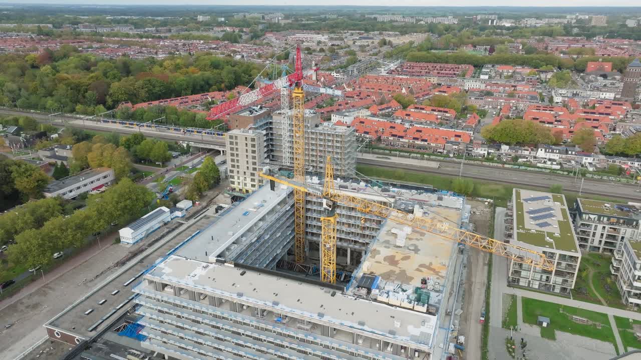 Aerial retreat out of construction site building new apartment for new residents