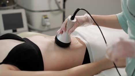 body rf lifting procedure. woman getting anti-cellulite and anti-fat therapy