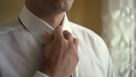 man adjusts beautiful and stylish tie