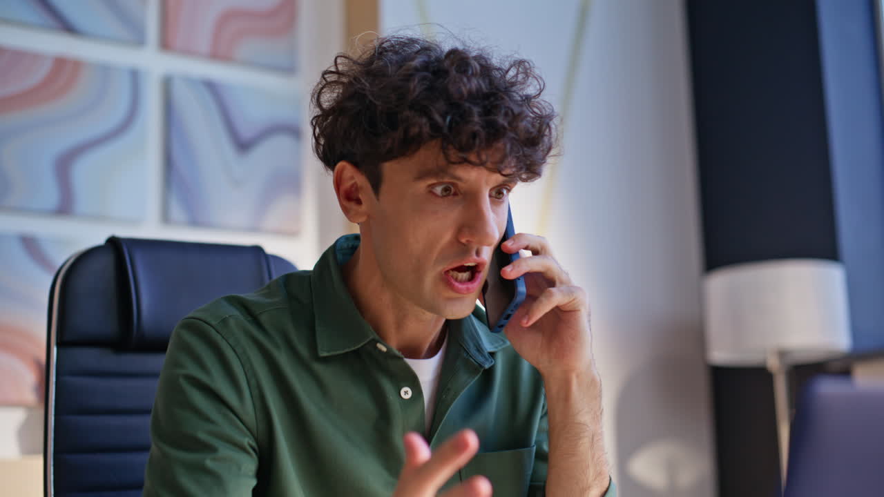 Nervous ceo quarrelling cellphone explaining work mistake in office closeup
