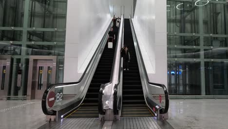 person descending on an escalator in a contemporary setting.