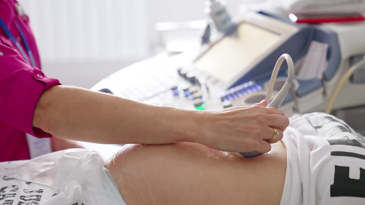 Sonogram procedure to a pregnant woman. Doctor does ultrasound in the hospital. Ultrasound investigation of pregnant woman. Pregnancy and healthcare concept.