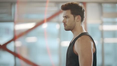 athletic sport man practicing exercises with dumbbell in turn.