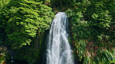 powerful waterfall falling tropical forest. drone shot of raging water flowing