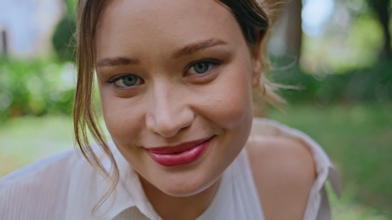 Portrait woman smiling park feeling content closeup. Attractive young brunette