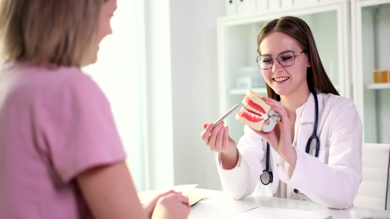 Dentist explaining dental model to patient