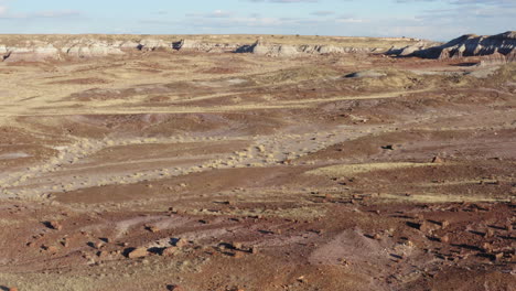 Drone-flying-over-a-dusty-badland-and-amazing-rock-formations-on-a-sunny-day