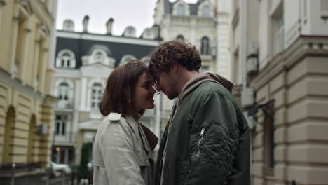 Love-couple-cuddling-together-on-urban-street.-Lady-and-guy-meeting-outdoor.