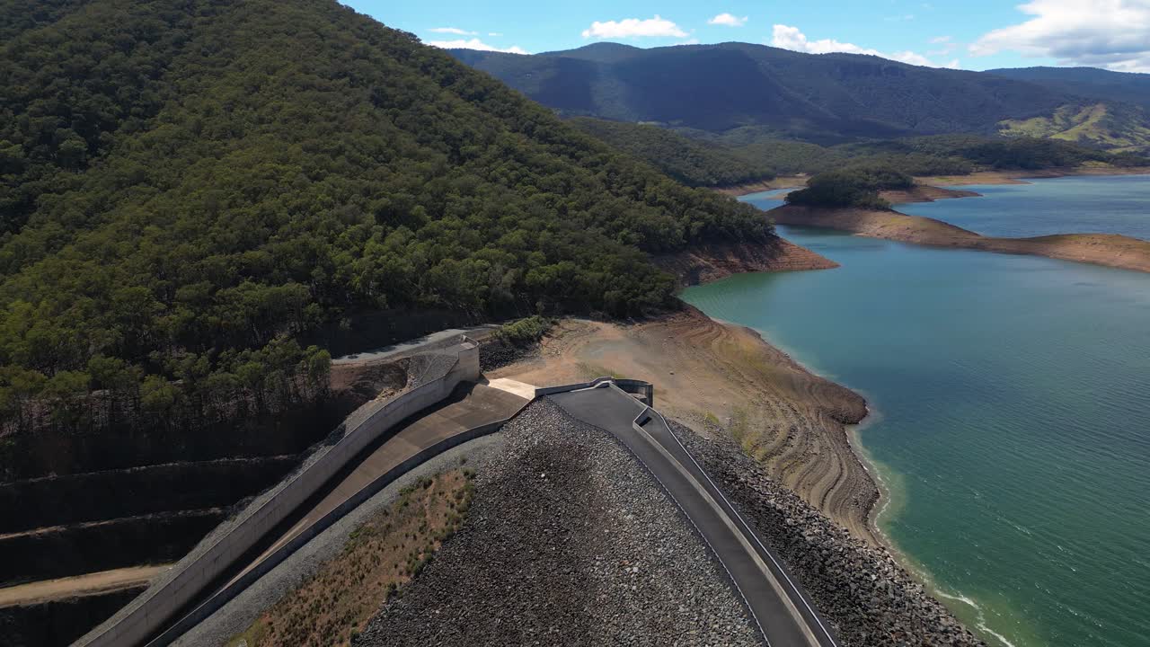Reversing aerial views over the Blowering Dam, spillway and Reservoir, New South Wales alpine region.