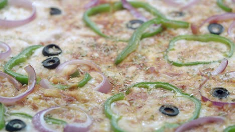 pizza with green peppers, red onion, and olives