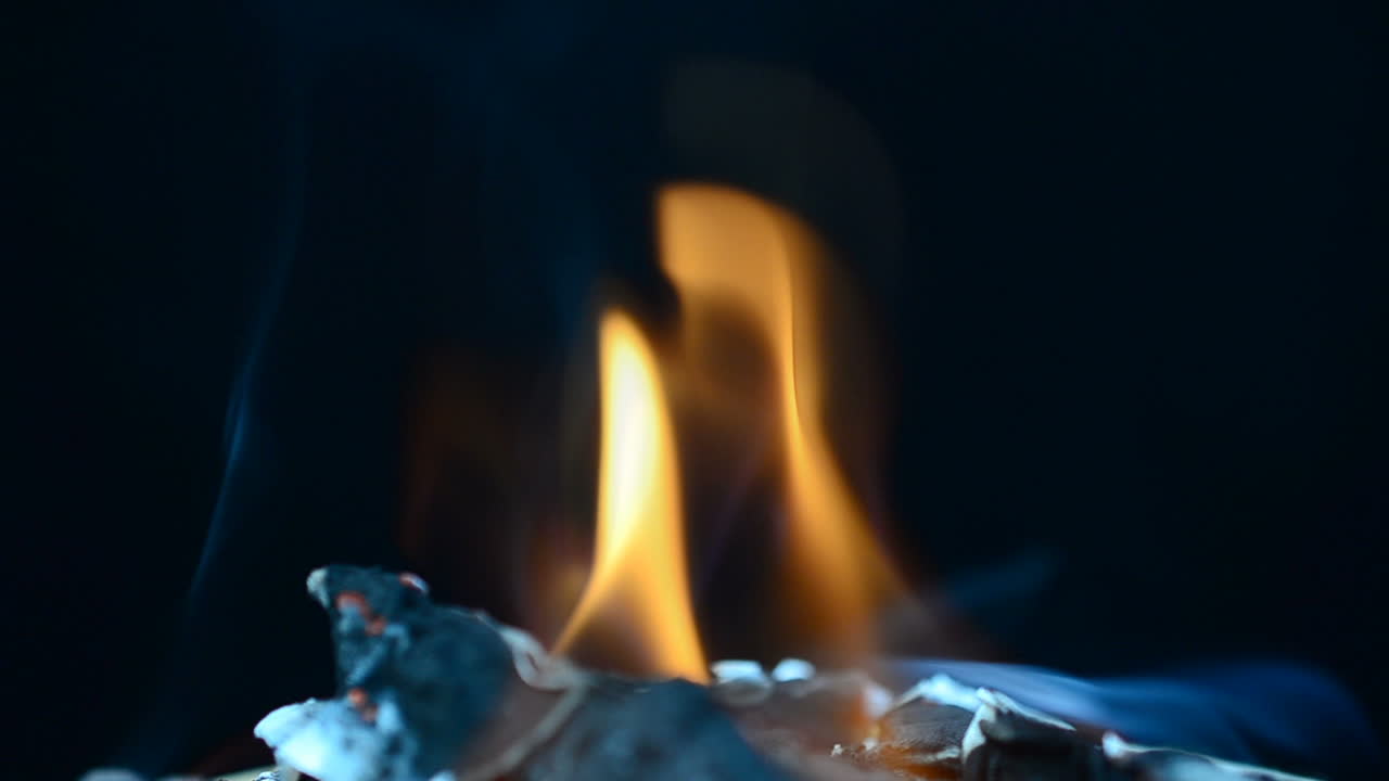 Slow Motion. The burning fabric. Slow Motion. The burning fabric on a black background