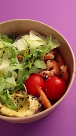 shrimp salad in a paper bowl