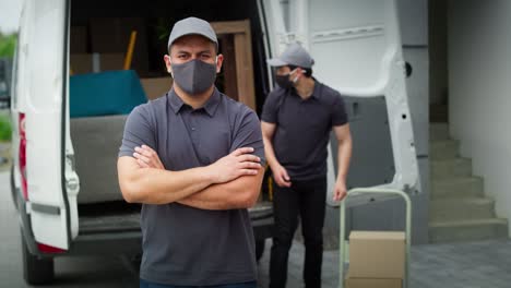 video portrait of delivery man standing in protective mask