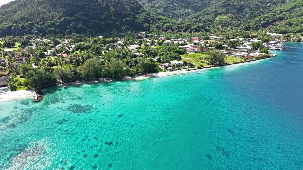 Aerial View of Huahine Island, French Polynesia. Turquoise Lagoon Water Along Green Coast and Coastal Village