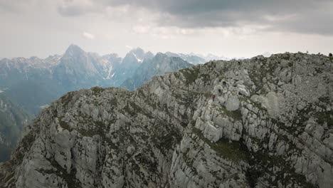 Drone-shot-of-the-mountain-Rombon,-other-moutanins-visible-in-the-background,-clouds-are-covering-the-sky