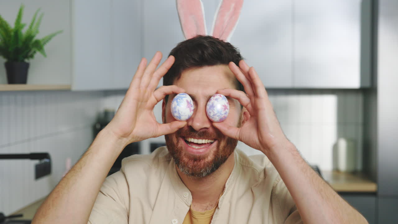 Man with Easter Bunny Ears and Eggs Covering Eyes