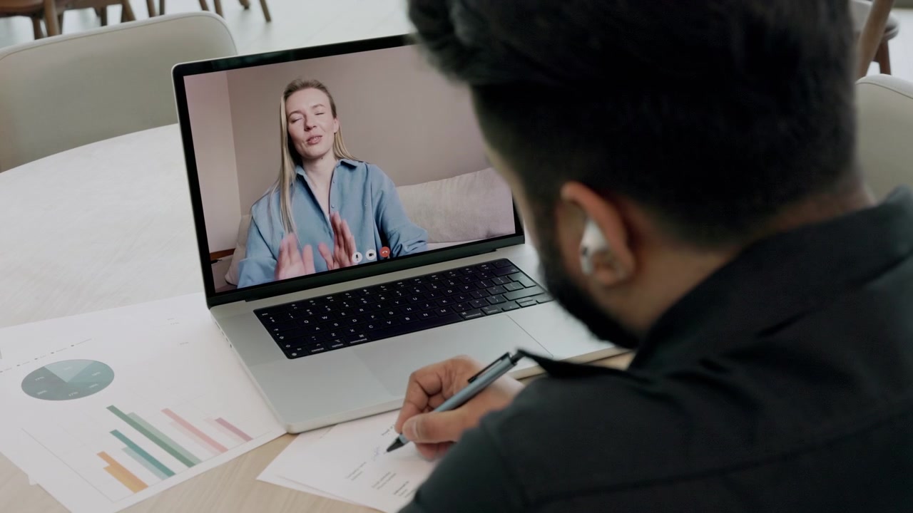 Man Participating in Video Conference Call on Laptop