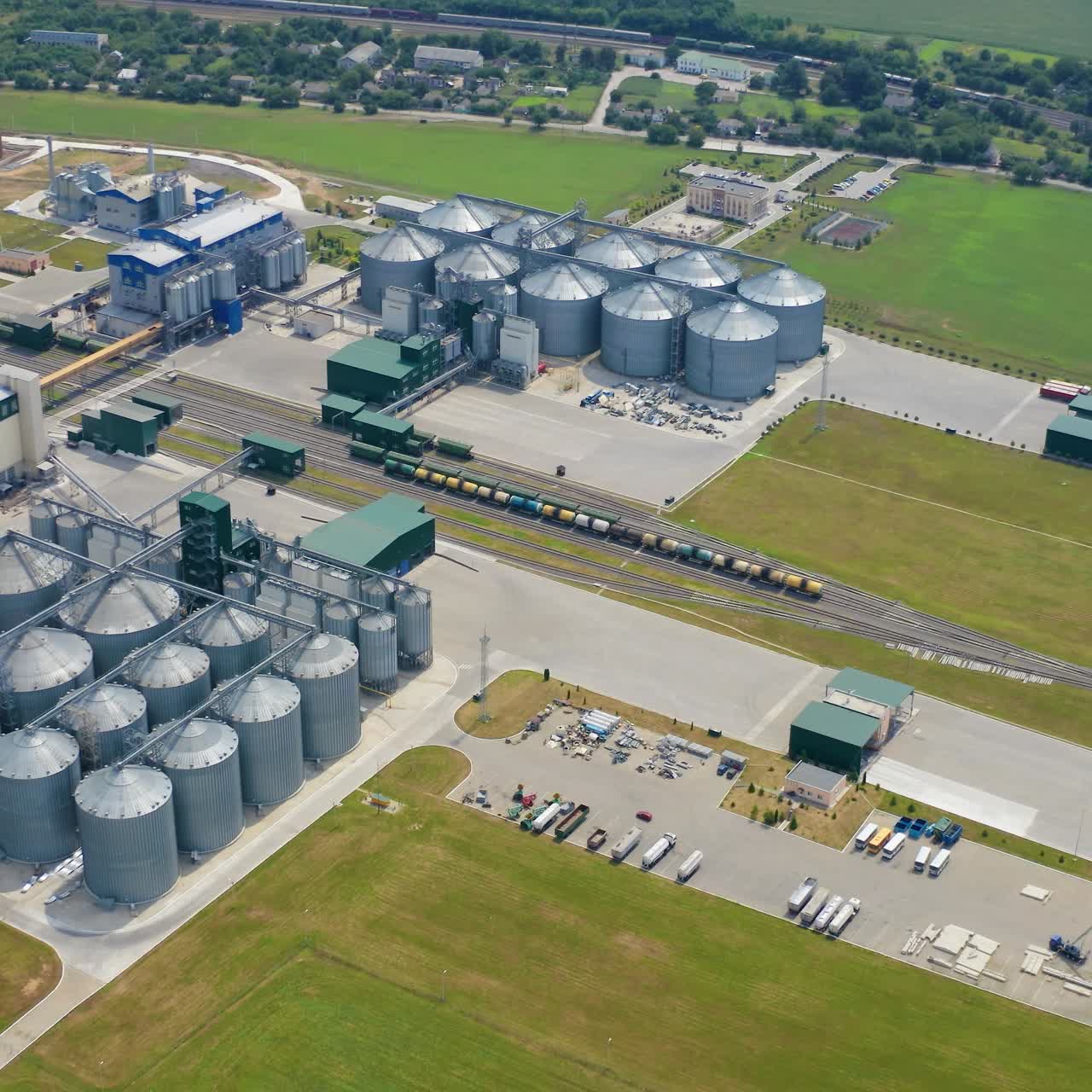 Modern industrial grain elevator storages. Aerial view of big factory metal storages
